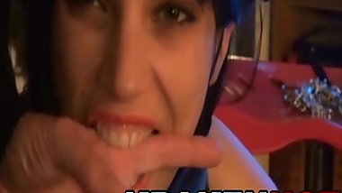 Sweet brunette little dog with pigtails tied at home. Part 2