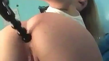 Teen toying her ass with a ribbed curling iron