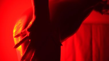 Solo nude girl in oil dancing in red light to the Weeknd music