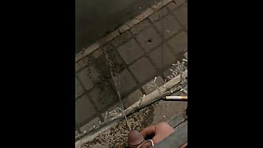 Drunk guy pisses from balcony