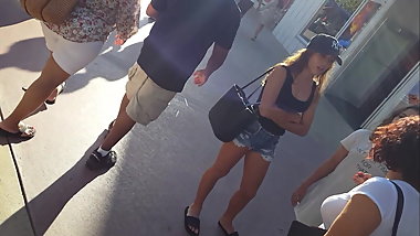 Candid voyeur hot teen in jean shorts shopping