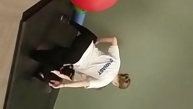 Voyeur gymnast stretching in leggings