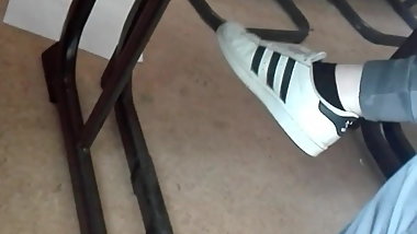 Teen dangling feet in sneakers