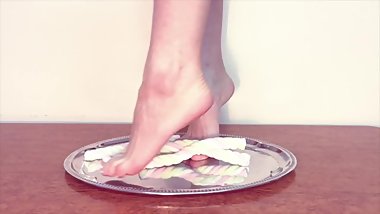 Hot horny young teen crushing sweet marshmallow with her sexy bare foot